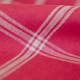 Ecru checkered linen fabric on a red background